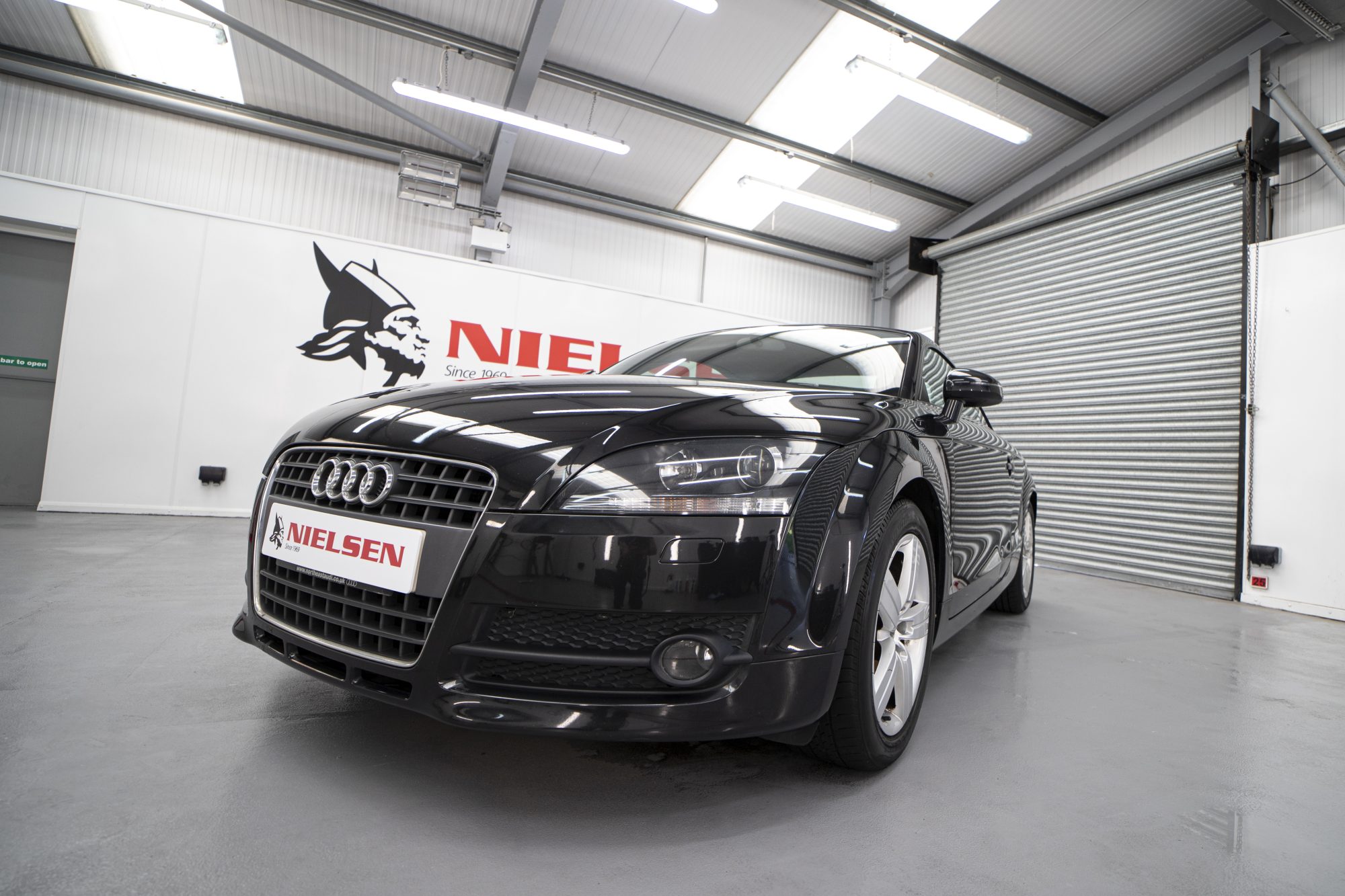 Black Audi car inside Nielsen detailing garage